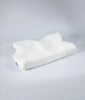 White CozyRest contoured memory foam neck pillow in a diamond-quilted cover with a small blue The Pillow Home tag, on a light grey background